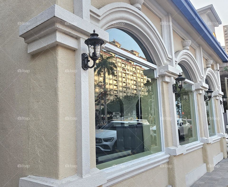 The windows of European-style buildings reflect the sunset-colored buildings