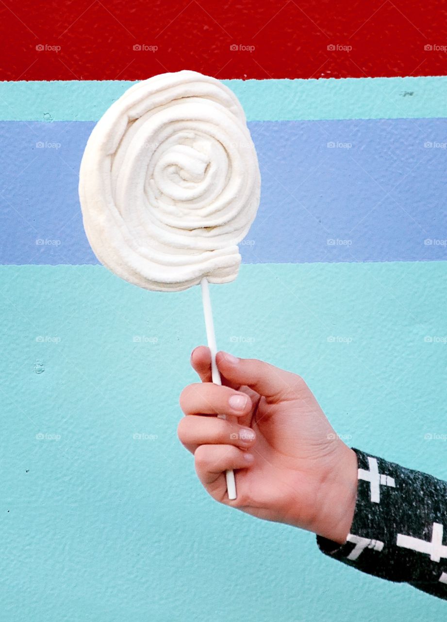 Hand holding lollipop