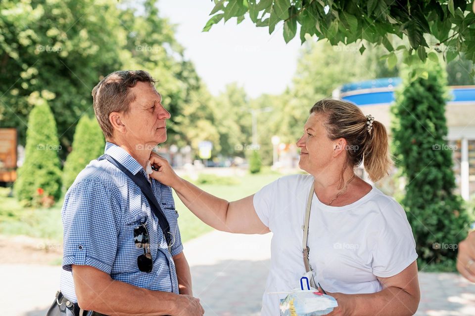 elderly couple walking outside