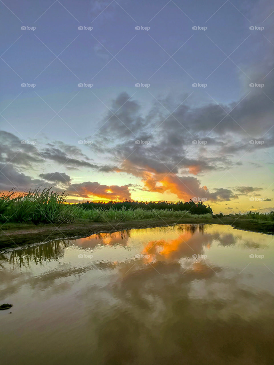 Sunset clouds water reflection