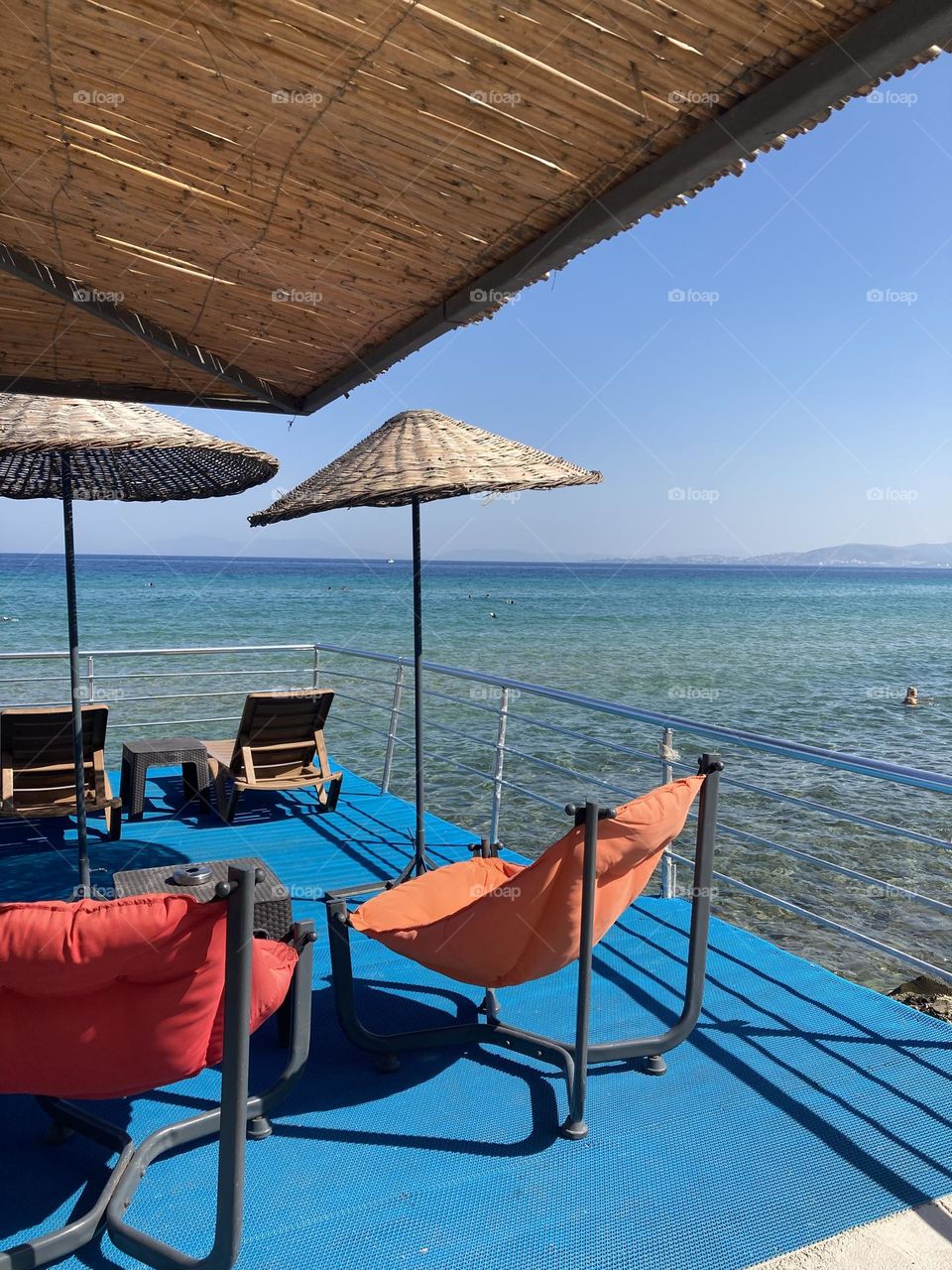 Sunny holidays I’m Turkey. Walk in the cute city and charming streets by the beach in Kusadasi. perfect blue sky and ocean view. Beach and the shore. To travel is to live. Gorgeous tall palm trees.