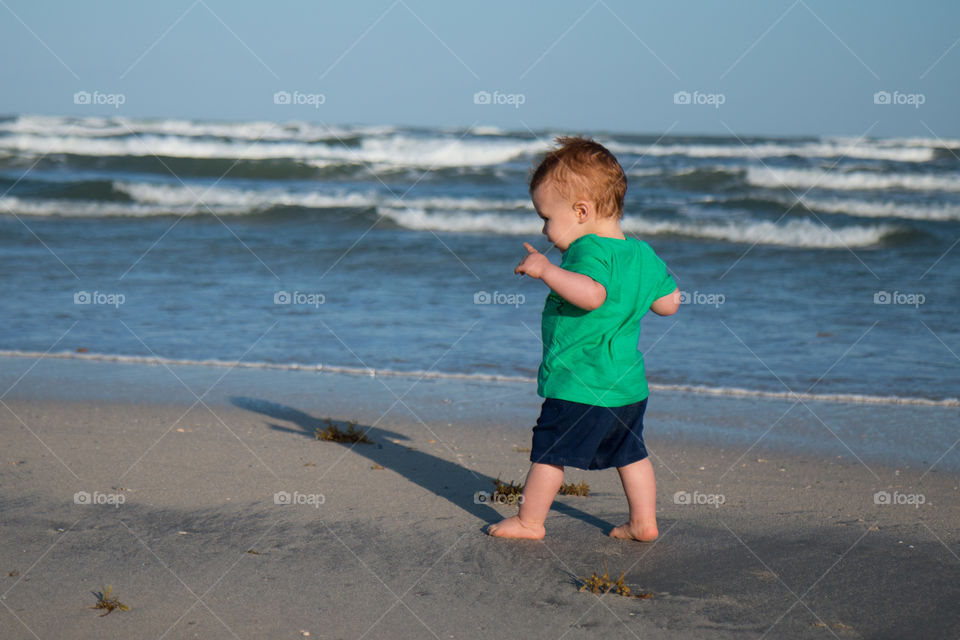 Baby walking the beach