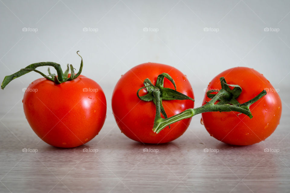 Three red tomatoes a vine