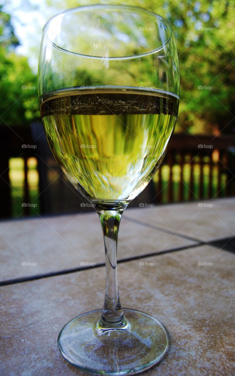 Wine Glass on table at sunset