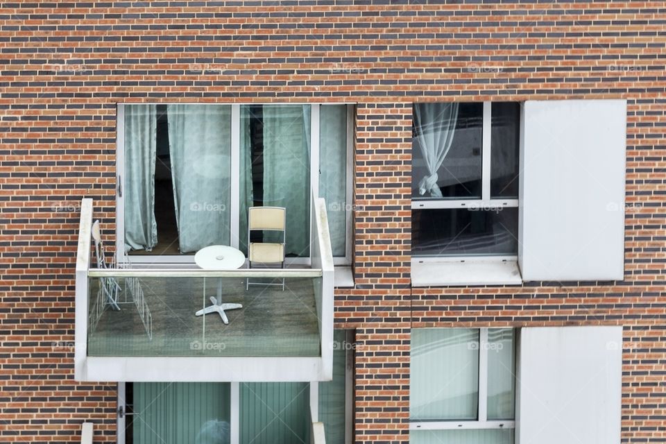 Facade of block with windows and balconies