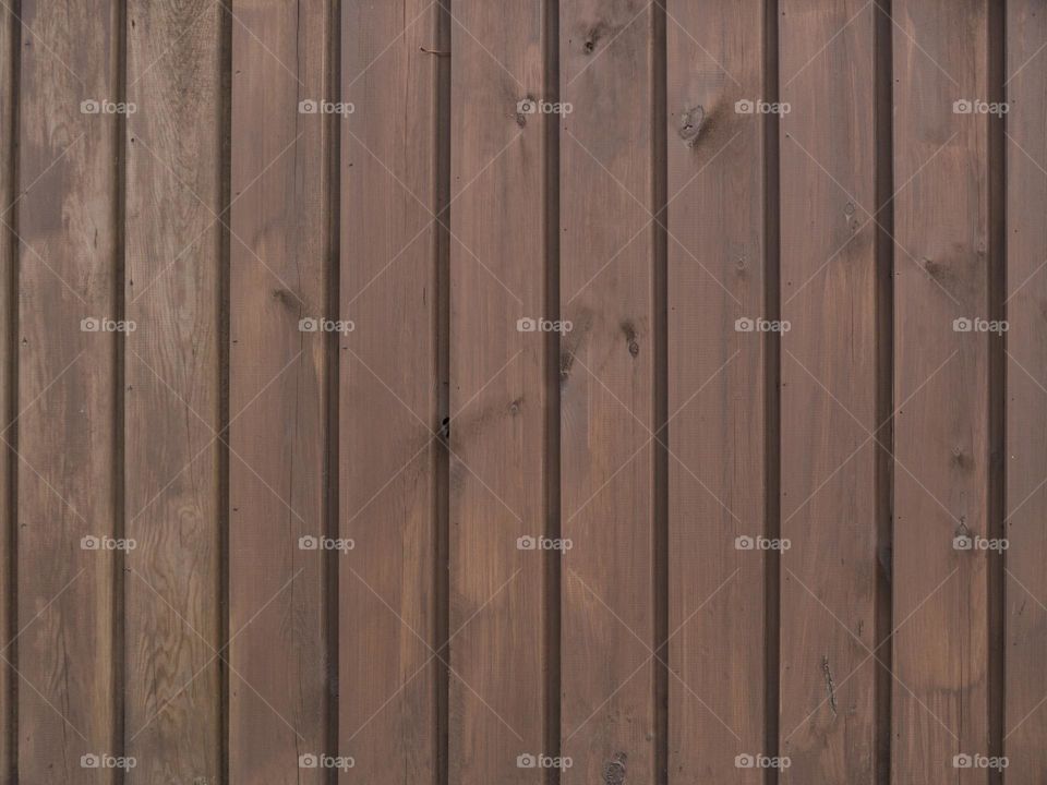 Vertical wooden boards gray on the wall as a background texture