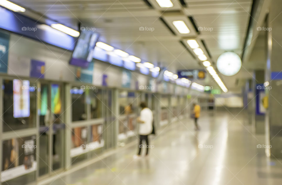 Blurry image of a passenger stand waiting for the subway