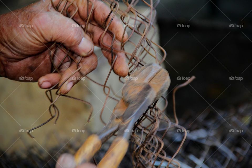 With bear hands and no hand glove during cutting the rusty wire