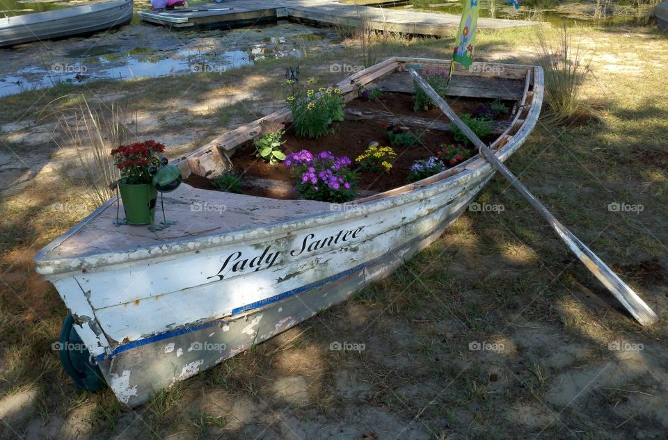 repurposed boat made flowerbed