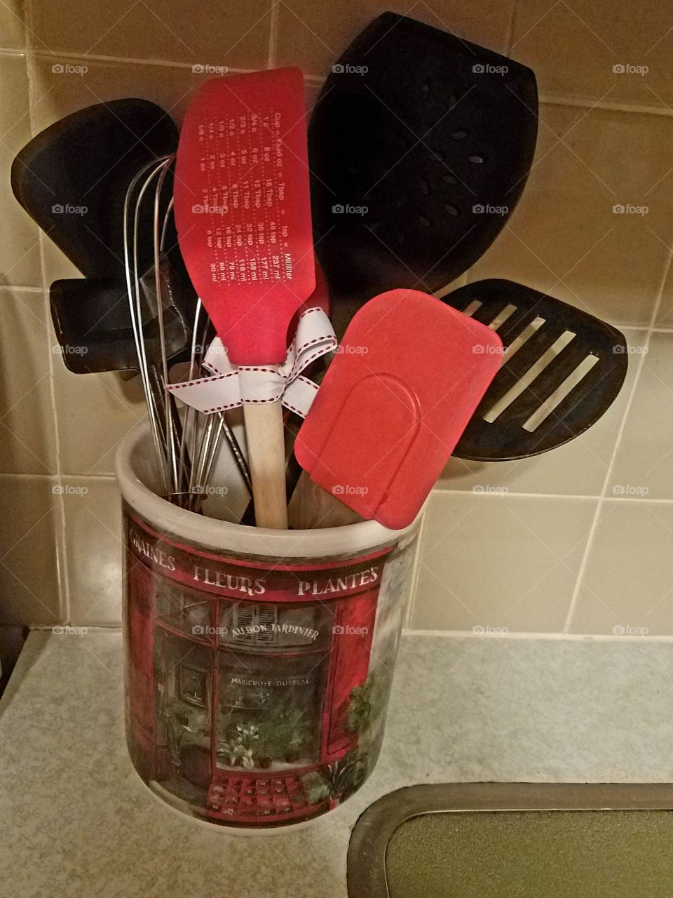 Kitchen utensils in decorative crock
