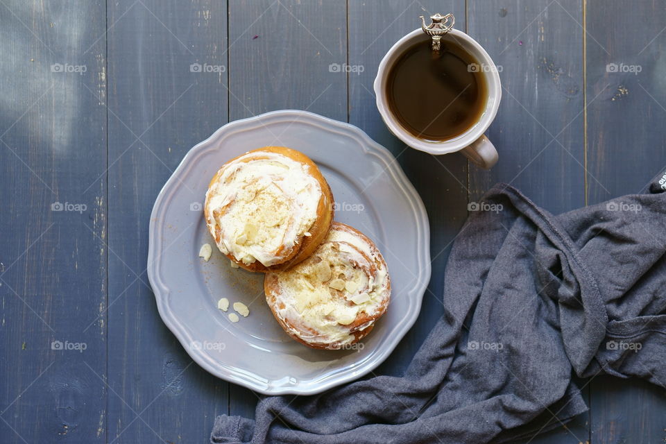 Cinnamon buns with coffees on table