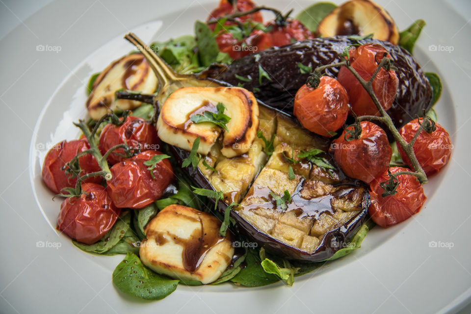 Roasted eggplant with roasted tomatoes and goat cheese salad 