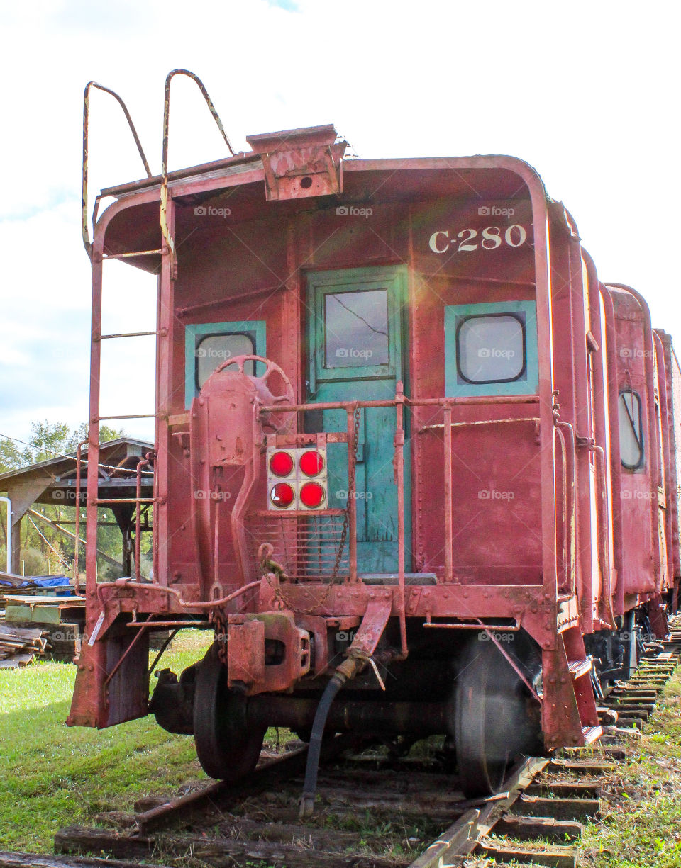 Old rusty B & O train car on tracks