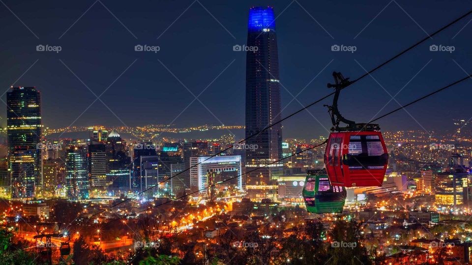 view of the illuminated city and the cable car cars adorning the scene