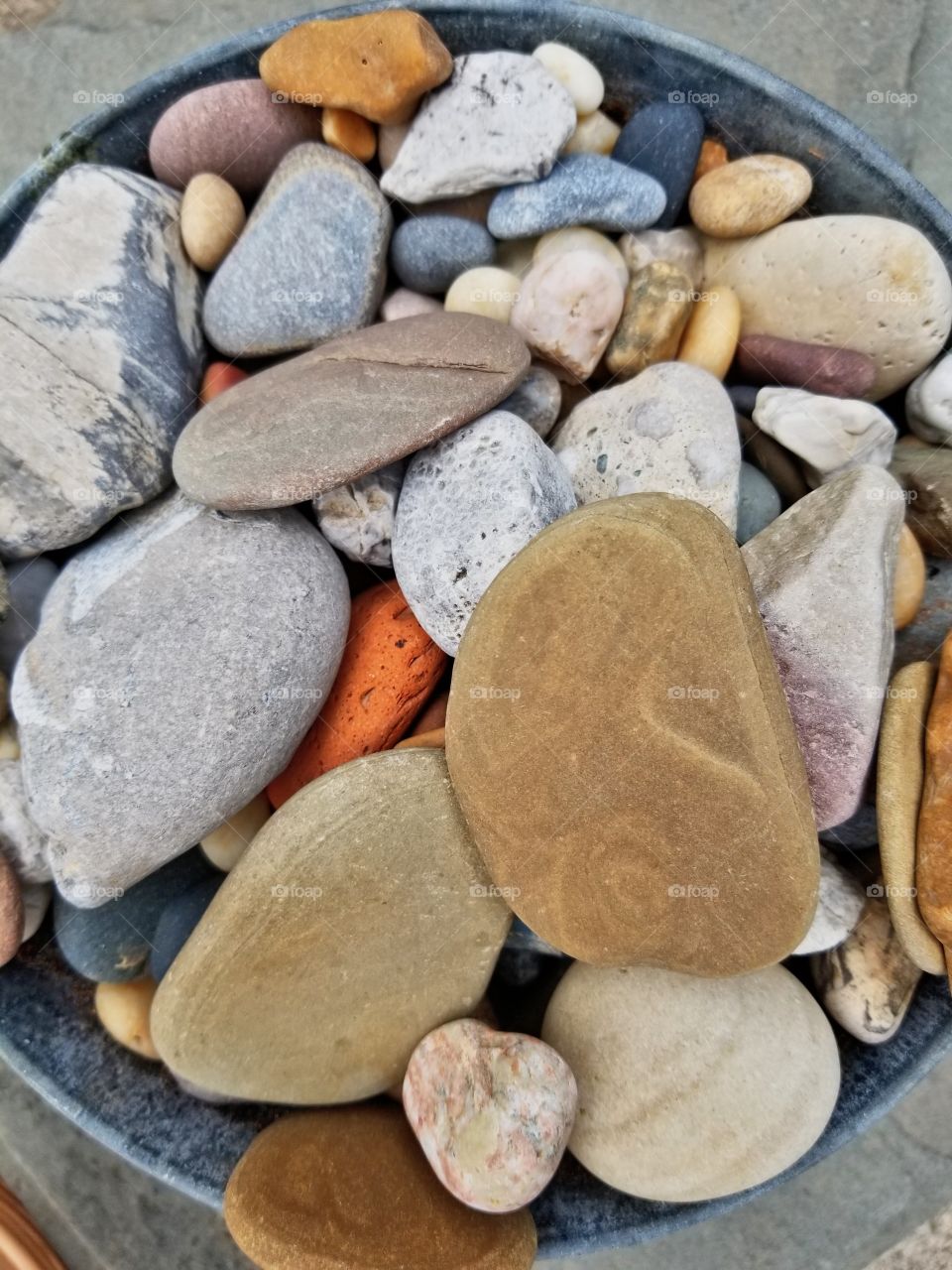 Collection of smooth soft rocks from many years tumbling in the water