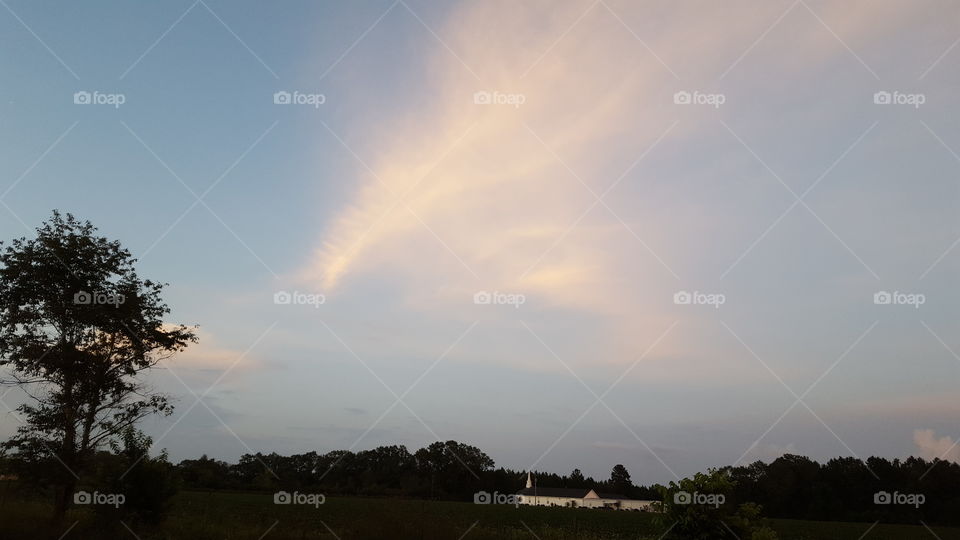 Thin Clouds Above the Church and Field