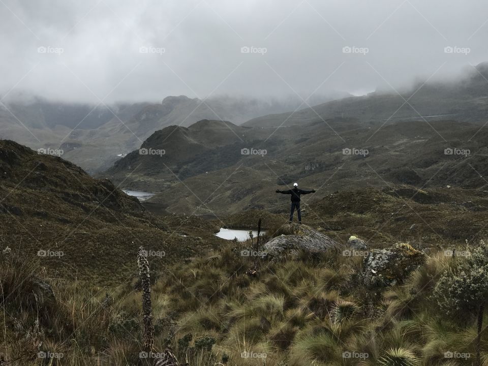 Taking in the vast expanse of the overcast day hilltop in Cajas National Park, Ecuador