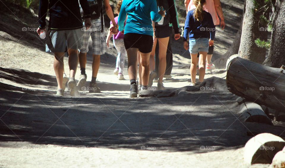 People, friends, family, tour group, hiking, trekking on a trail of a mountain