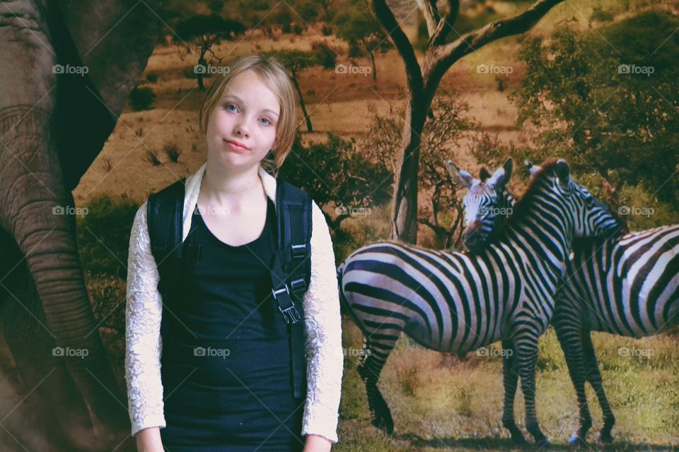 Girl posing. Girl in front of wild animals background