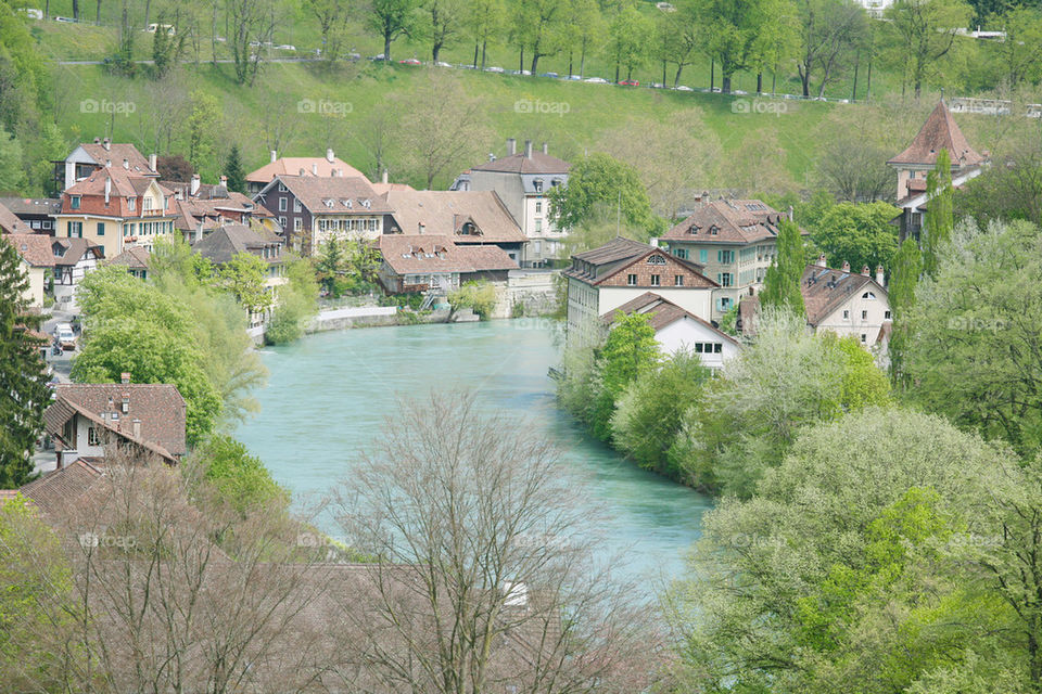stunning view of a beautiful town around the lake during the summer.