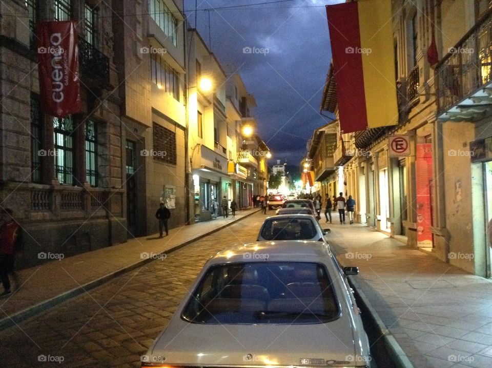 Cuenca streets at night. Spanish flags hanging in Cuenca, Ecuador streets at night
