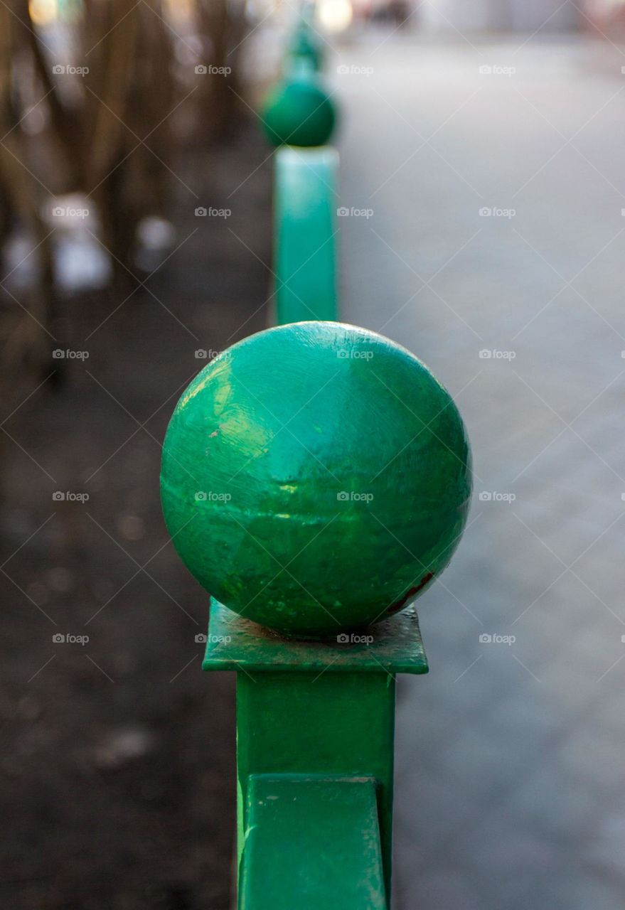 green ball on the fence