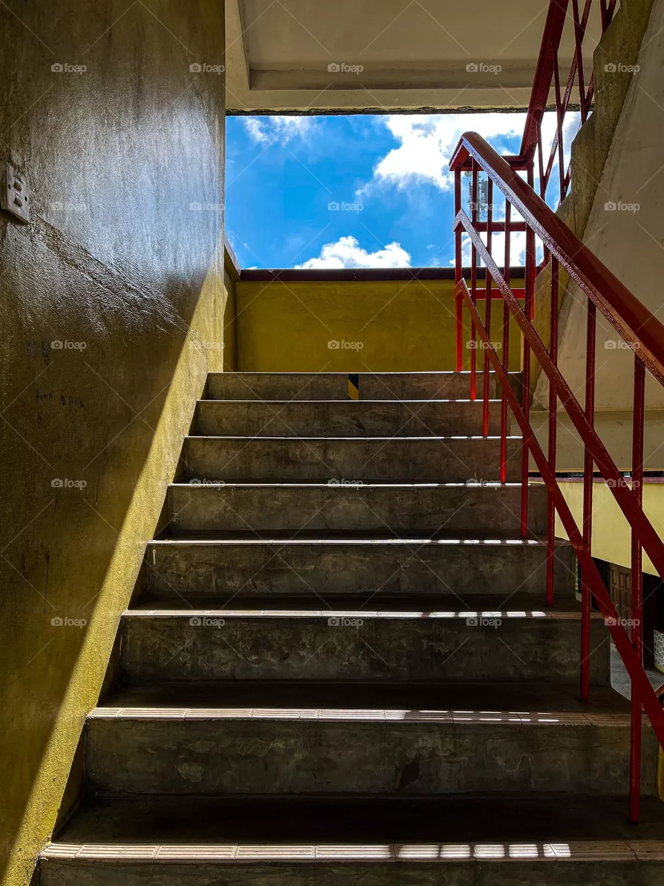 Stairway to the blue cloudy sky