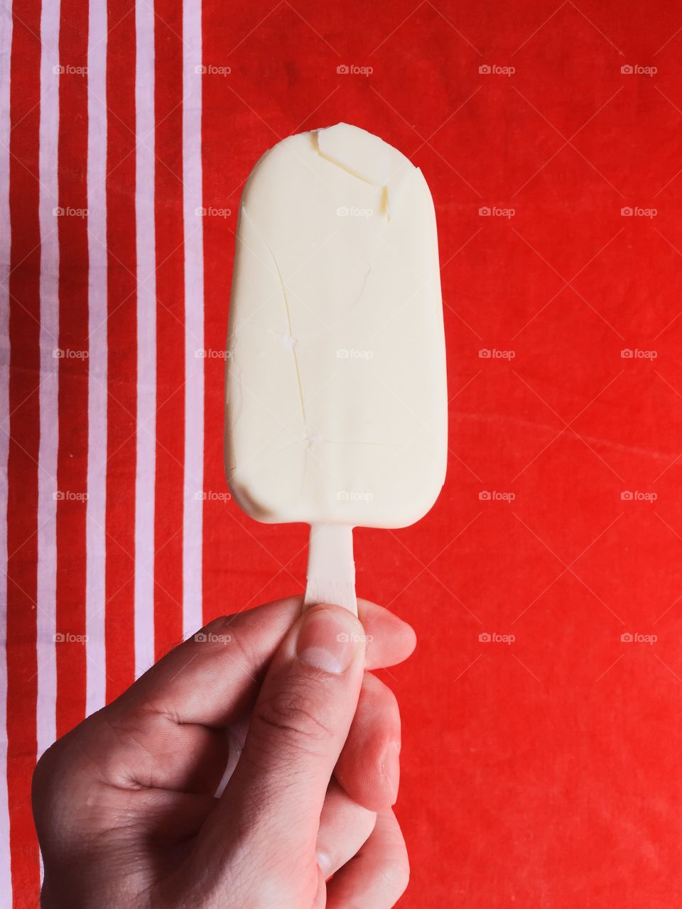 Hand holding ice cream popsicle