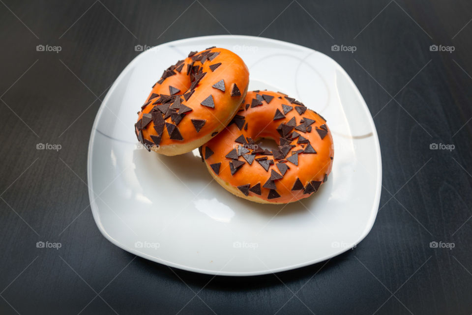 Two donuts in halloween colors.