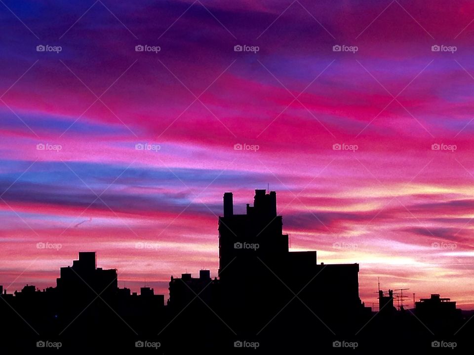 Pink sunset with silhouette skyline