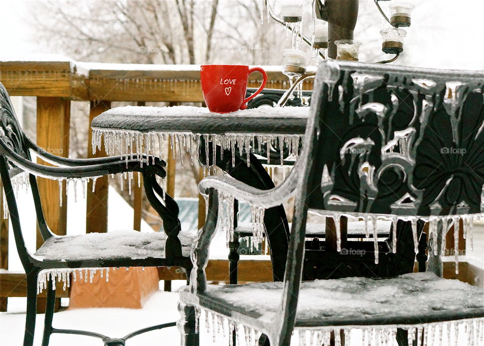 Enjoying a cup of hot coffee on a frigid icy morning during the winter.  