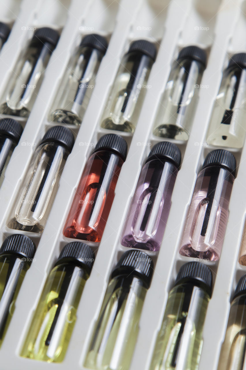 Catalogue with perfume sample bottles, for sale of fragrances of various colors and aromas