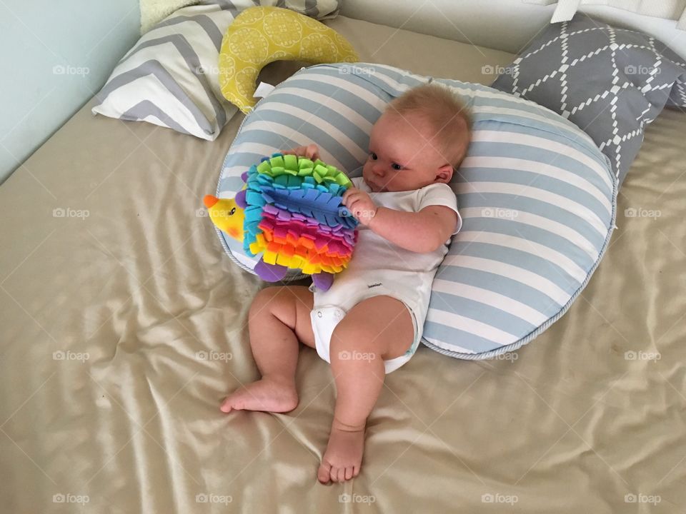 Baby boy playing with a toy 

