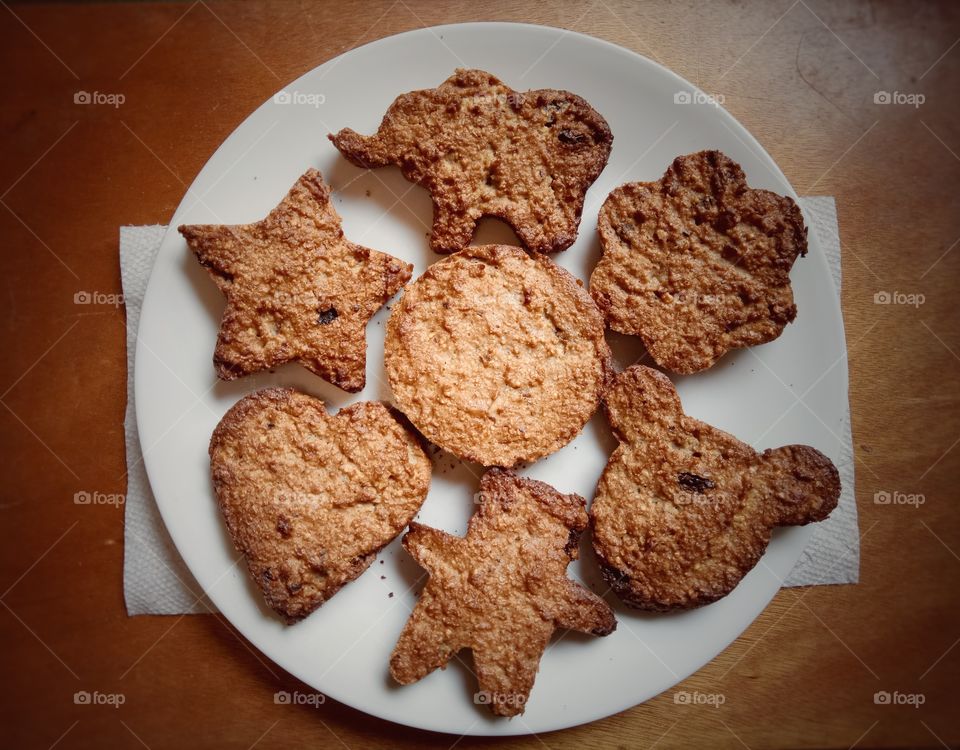 Matzo meal cookies in shapes and designs. Breakfast and snacks. Brown, white round plate.