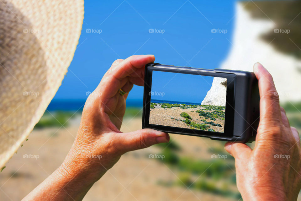 Woman taking picture of cliff in mobile