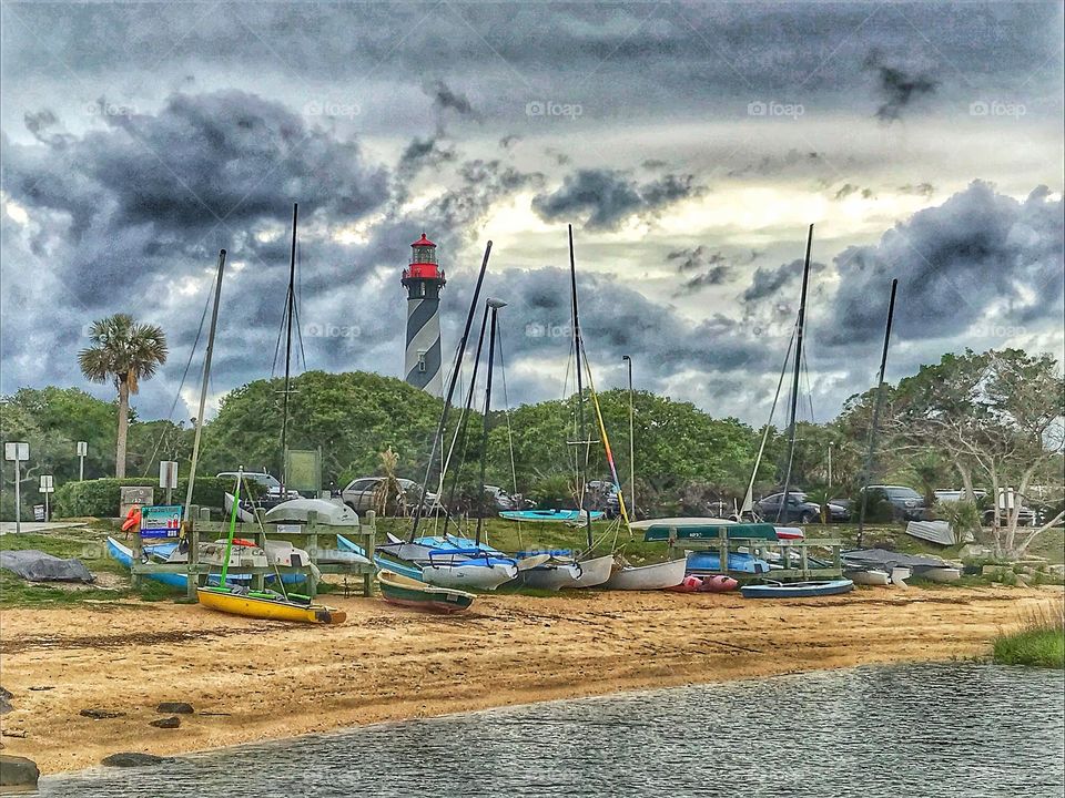 Boats beached on Anastasia Island. In view Saint Augustine lighthouse.