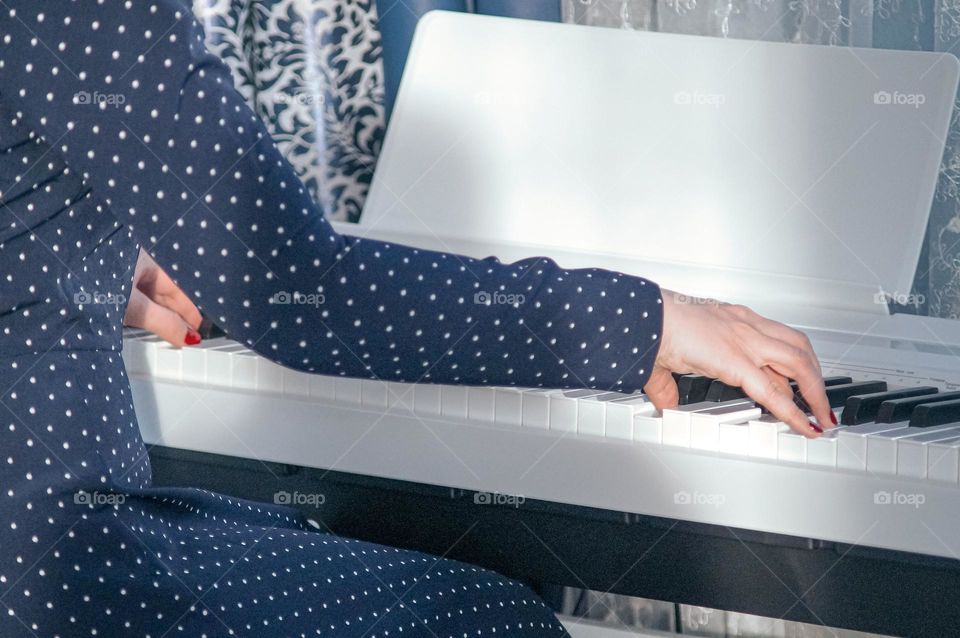 Cute girl playing the white piano