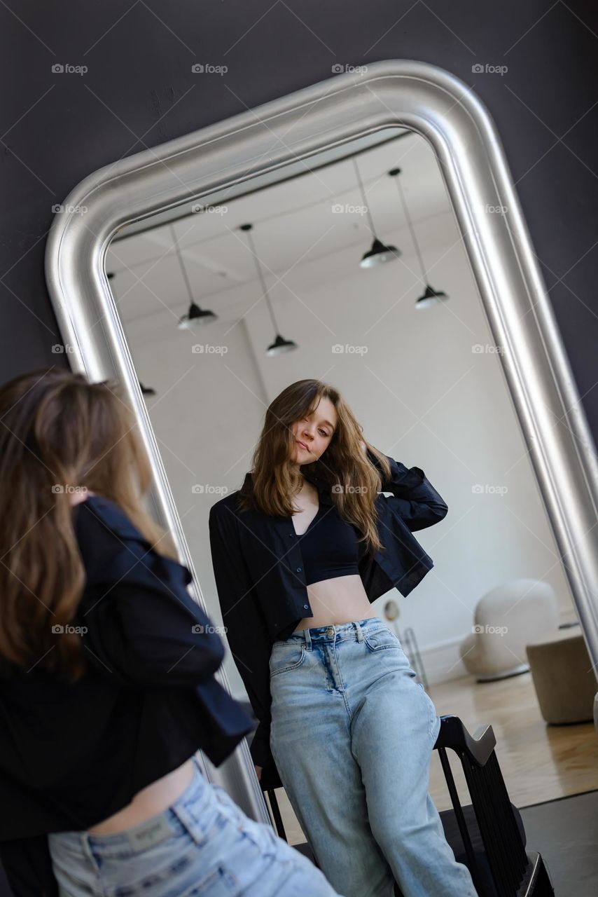 Beautiful girl reflected in the mirror