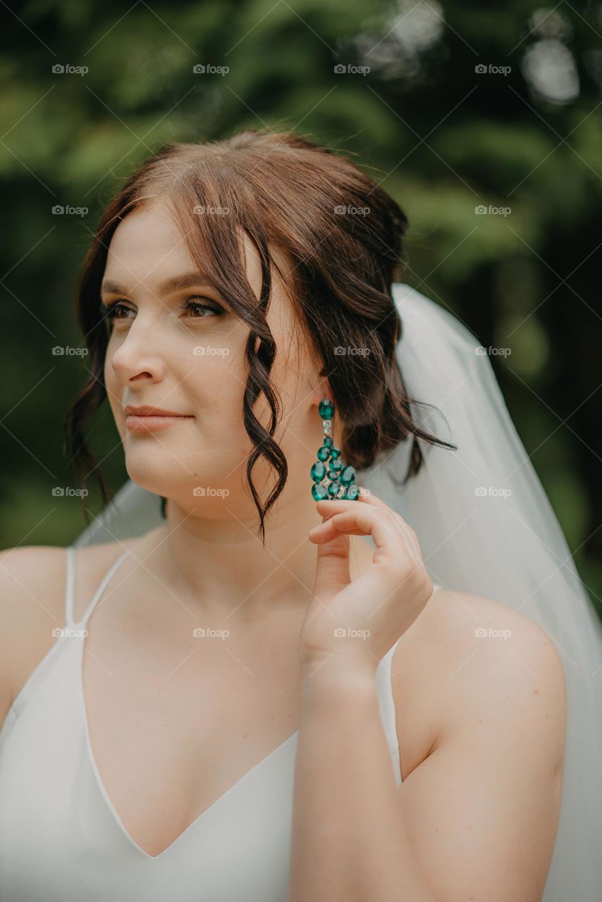 Green earrings of the bride