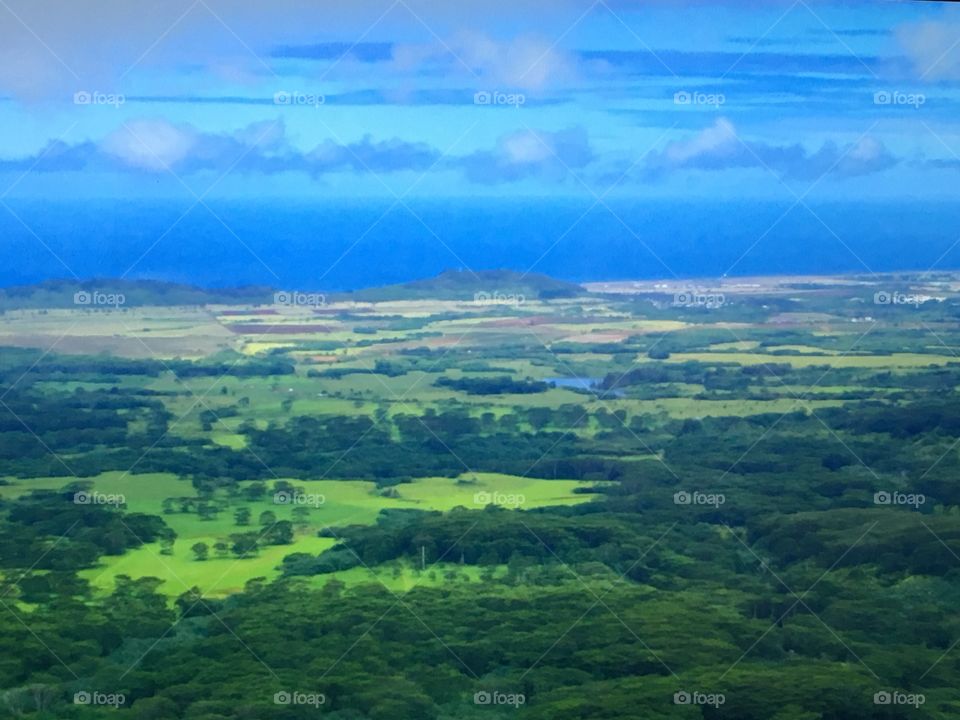 View across Kauai to Pacific Ocean from propeller plane. Flying in tiny propeller plane was one of most exciting experiences of my life! Imagine riding roller coaster for an hour & 1/2 a couple thousand feet over some of the most beautiful terrain!