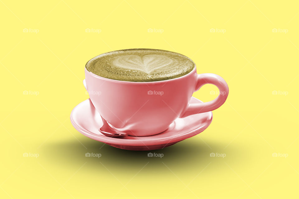 Hot coffee Espresso  topped with a heart-shaped milk on a yellow background with clipping path.