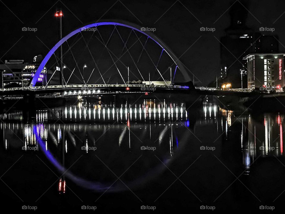 A stunning circle of light from the Clyde Arc bridge element and its reflections in the Clyde River. This 96_meter bridge was put i to use in 2006 and crosses the River at an angle so that users passing it are constantly in the bend