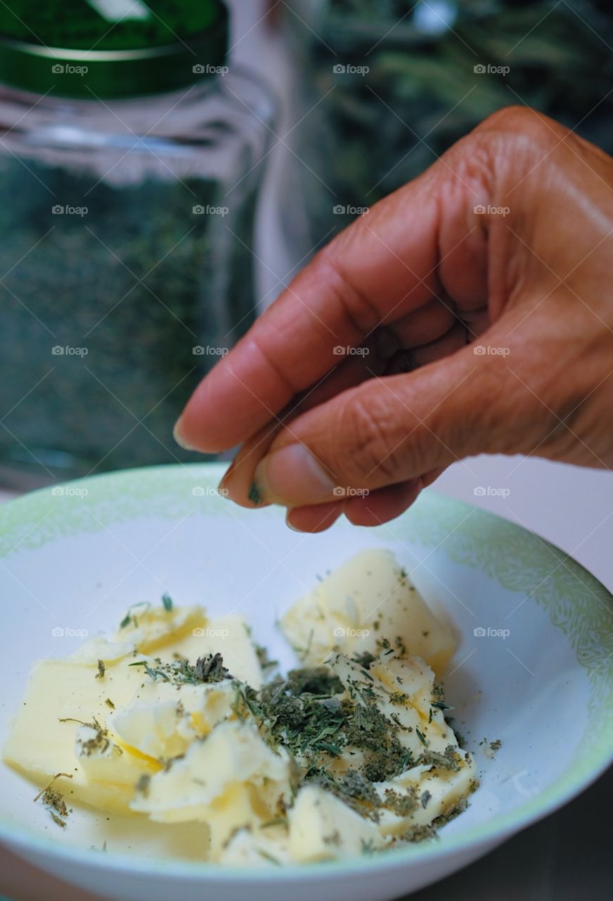 Woman cooking, Preparing Thanksgiving dinner, Woman cooking, Sprinkling herbs into butter, Using spices while cooking, Traditional American meals, Food preparation, Preparing Food in the kitchen 