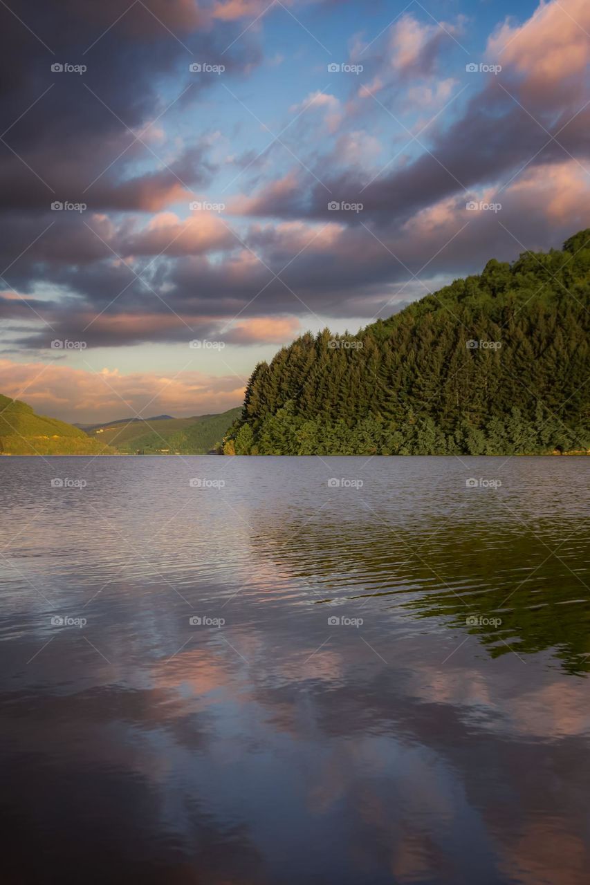 Scenic view of lake against sky during sunset.