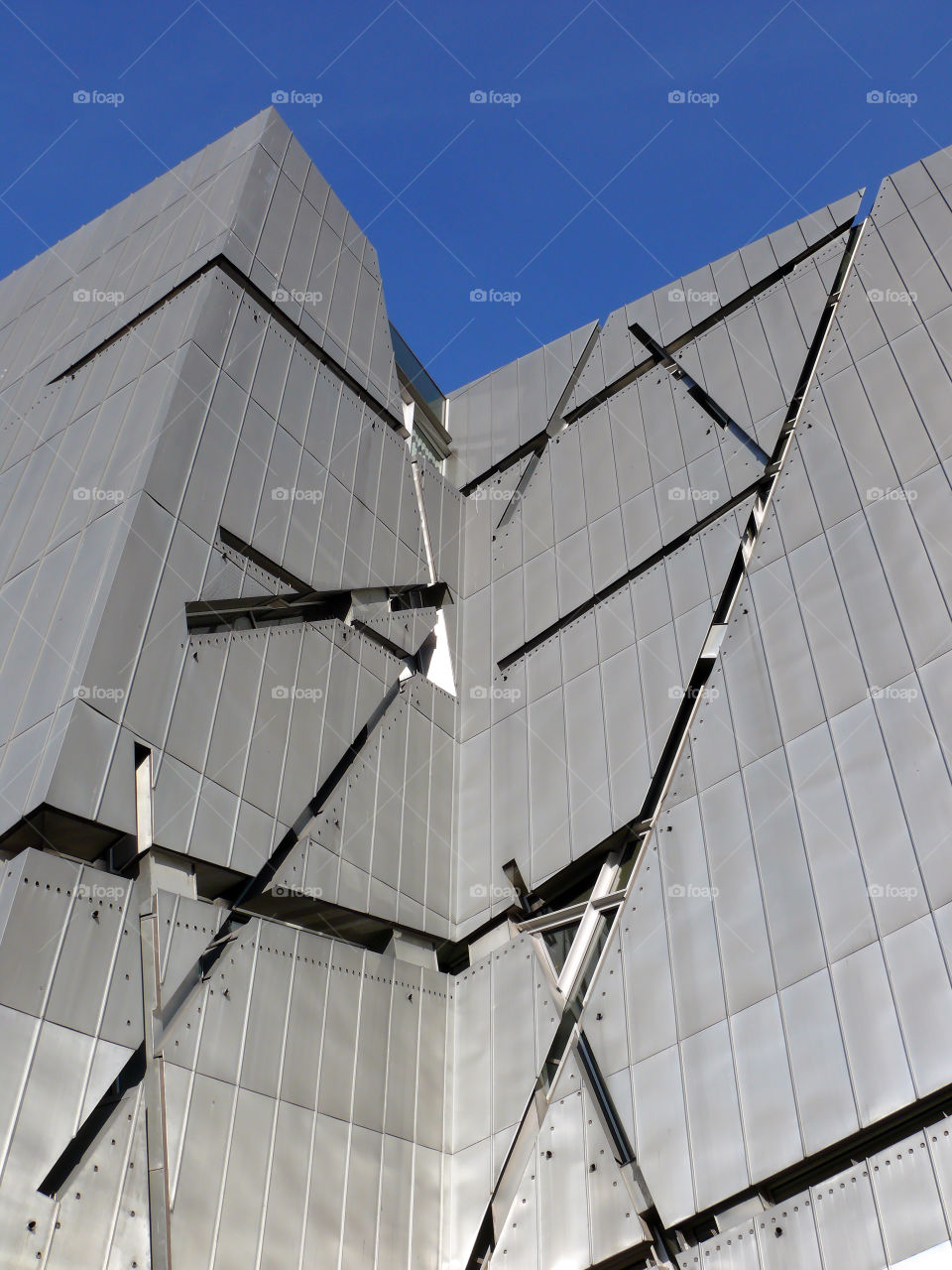 Low angle view of built structure of the Jewish Museum Berlin against clear sky.