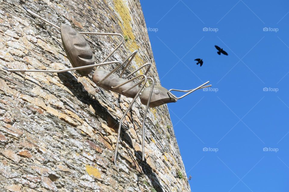 Giant iron ant on the tower of a castle
