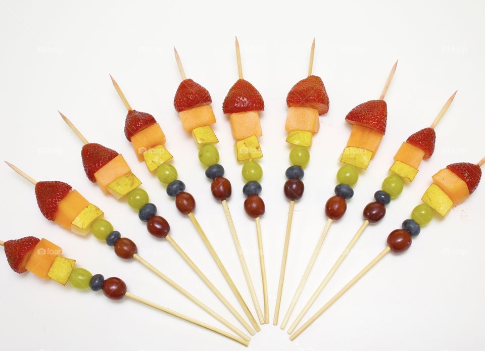 A rainbow of fruit on skewers 