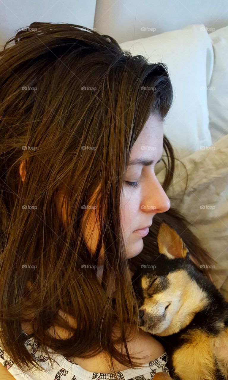 Close-up of a teenage girl sleeping with her dog