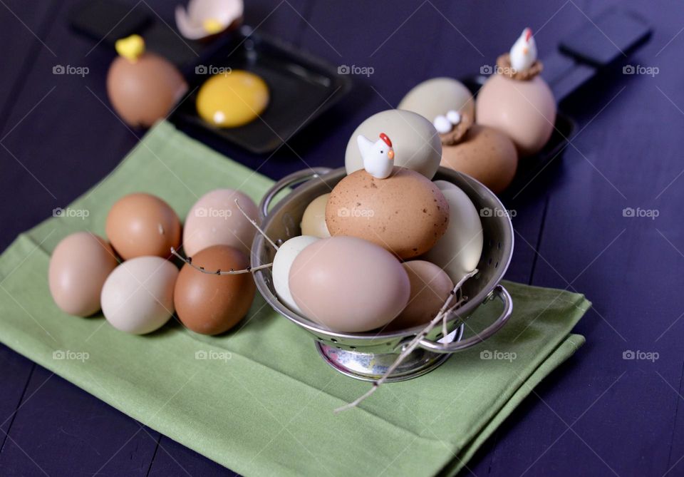 A colorful scene with eggs and tiny chickens and chicks