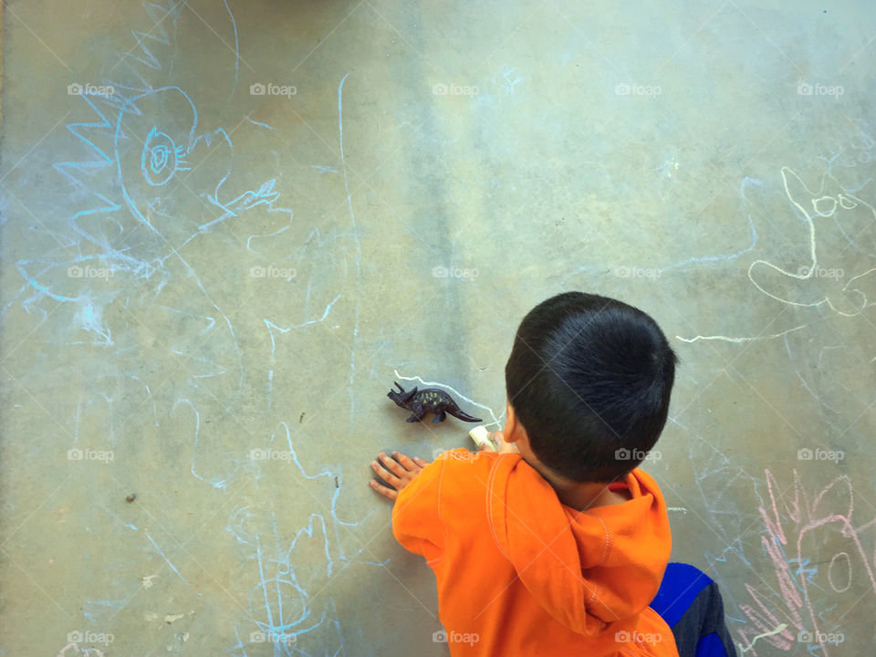 Boy tracing dinosaur 